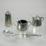 An early 20th century silver three piece condiment set, comprising a mustard, salt and pepper,