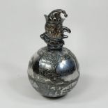 A novelty silver plated globe paperweight, surmounted by Mr Punch, inscribed 'Always on Top', by J.