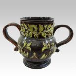 A Castle Hedingham brown glazed pottery twin handled vase, with foliate decoration,