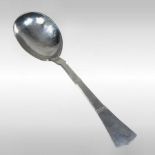 A Danish Arts and Crafts silver serving spoon, of plain shape, with hammer beaten decoration,