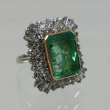 An unmarked 18 carat white gold emerald and diamond cluster ring,