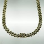 A 9 carat gold flexible link necklace, with v shaped links and a hinged clasp,