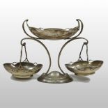 An Edwardian silver epergne, having a central oval bowl and suspended by a pair of baskets,