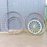 A pair of antique iron cartwheel rims, 144cm diameter,