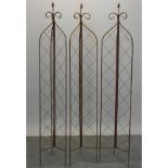 A folding metal garden lattice spire, together with two others,