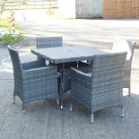 A grey rattan garden table,