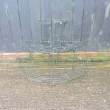 A pair of green painted iron graduated plant stands,