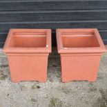 A pair of faux terracotta garden pots,