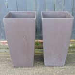 A pair of large brown garden pots,