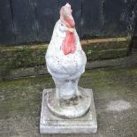 A reconstituted stone garden model of a cockerel, on a plinth base,