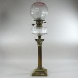 A 19th century brass oil lamp, in the form of a Corinthian column, with an etched glass shade,