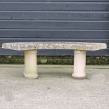 A reconstituted stone garden bench,