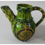 A Castle Hedingham green glazed pottery jug, with applied geometric decoration and medallions,