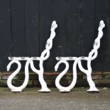 A pair of white painted cast iron bench ends,