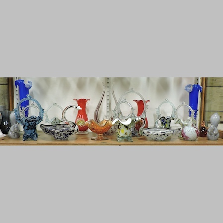 A shelf of coloured glass, to include vases and Murano baskets,