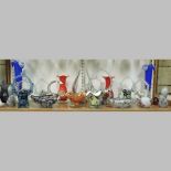 A shelf of coloured glass, to include vases and Murano baskets,