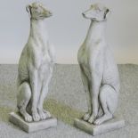A pair of reconstituted stone dogs,