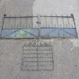 A pair of black painted wrought iron gates, each 136cm,