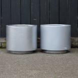 A pair of silver coloured garden pots,