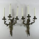 A pair of Rococo style bronze three branch wall sconces,
