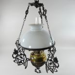 A Victorian brass oil lamp, with an etched glass shade, manufactured by Palmer and Co,