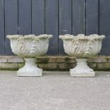 A pair of reconstituted stone garden planters,