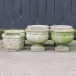 A set of four reconstituted stone urns, 32cm high,
