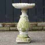 A reconstituted stone bird bath,