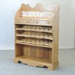 A pine wine rack, with a tiled back,