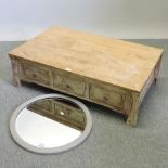 A rustic pine coffee table, together with a circular wall mirror,