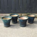 A set of four matching blue glazed plant pots,