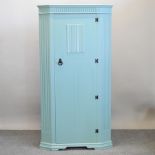 An early 20th century green painted single wardrobe, with linen fold decoration,