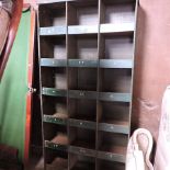 A mid 20th century industrial set of metal shelves, fitted with pigeon holes,