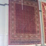 A Bokhara style carpet, with all over medallions on a red ground,