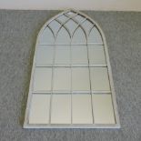 An arched garden mirror,