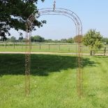 A rusted metal garden arch,