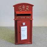 A GPO style red painted metal postbox,