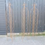 A set of three small folding metal garden lattice spires,