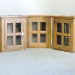 Three glazed oak hanging kitchen cabinets,