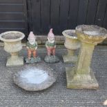 A reconstituted stone bird bath on a pedestal, 63cm high, together with another,