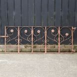 An ornate wrought iron garden gate,