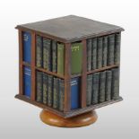 An Edwardian revolving bookcase, containing The Complete Works of Shakespeare in miniature,