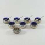 A set of eight Victorian silver open salts, each of half gadrooned circular shape, by Elkington,