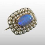 A Victorian opal and pearl brooch, of oval shape, set with two graduated rows of pearls,