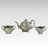 A George IV Irish three-piece silver tea service, of circular shape, relief decorated with flowers,