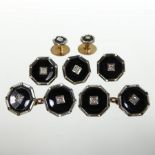 A set of early 20th century 9 carat and 18 carat gold, diamond and black enamelled dress studs,