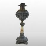 A 19th century American marble and brass oil lamp, with an ornate metal reservoir and scrolled base,