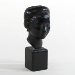 An oriental patinated bronze head, of a young lady, on stand,