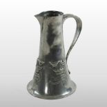 An Art Nouveau Tudric pewter jug, relief decorated with stylised flowers,