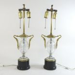 A pair of early 20th century French glass and brass table lamps, on ebonised bases,